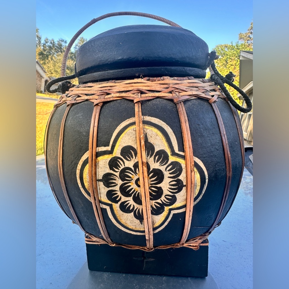 Round Asian woven basket with lid. Dark wood with natural rattan.